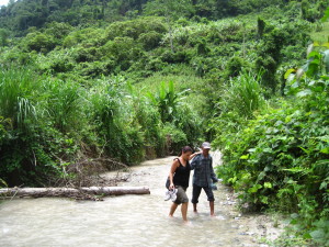 Wan helping Vanessa cross one of the 25 rivers barefoot