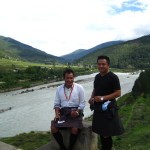 Pema and Jimmy taking a break by the river with the longest suspension bridge